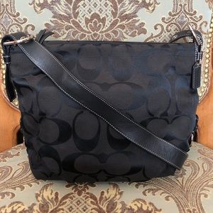 Black crossbody Coach purse with logo